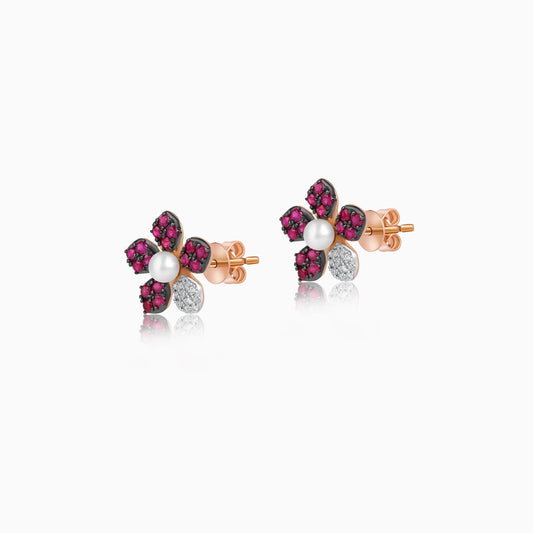 18k rose gold pair of earrings with a flower shape decorated with natural diamonds, ruby stones and pearls