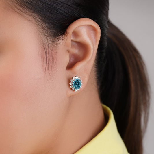 18K white gold earrings decorated with natural blue London Topaz stone surrounded by natural diamond stones