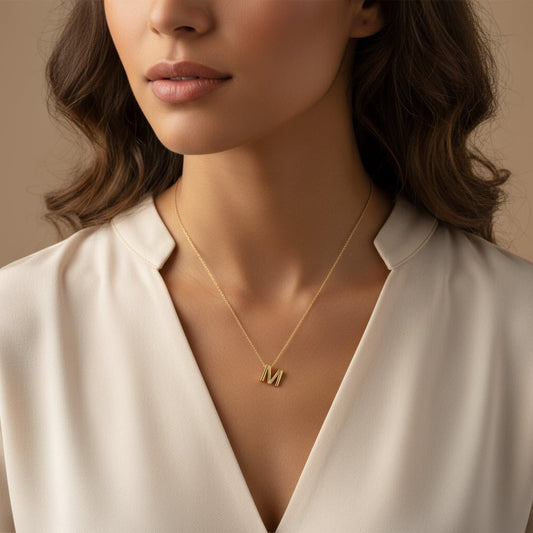 18k yellow gold necklace with letter “M” decorated with single natural diamond stone from Alpha collection