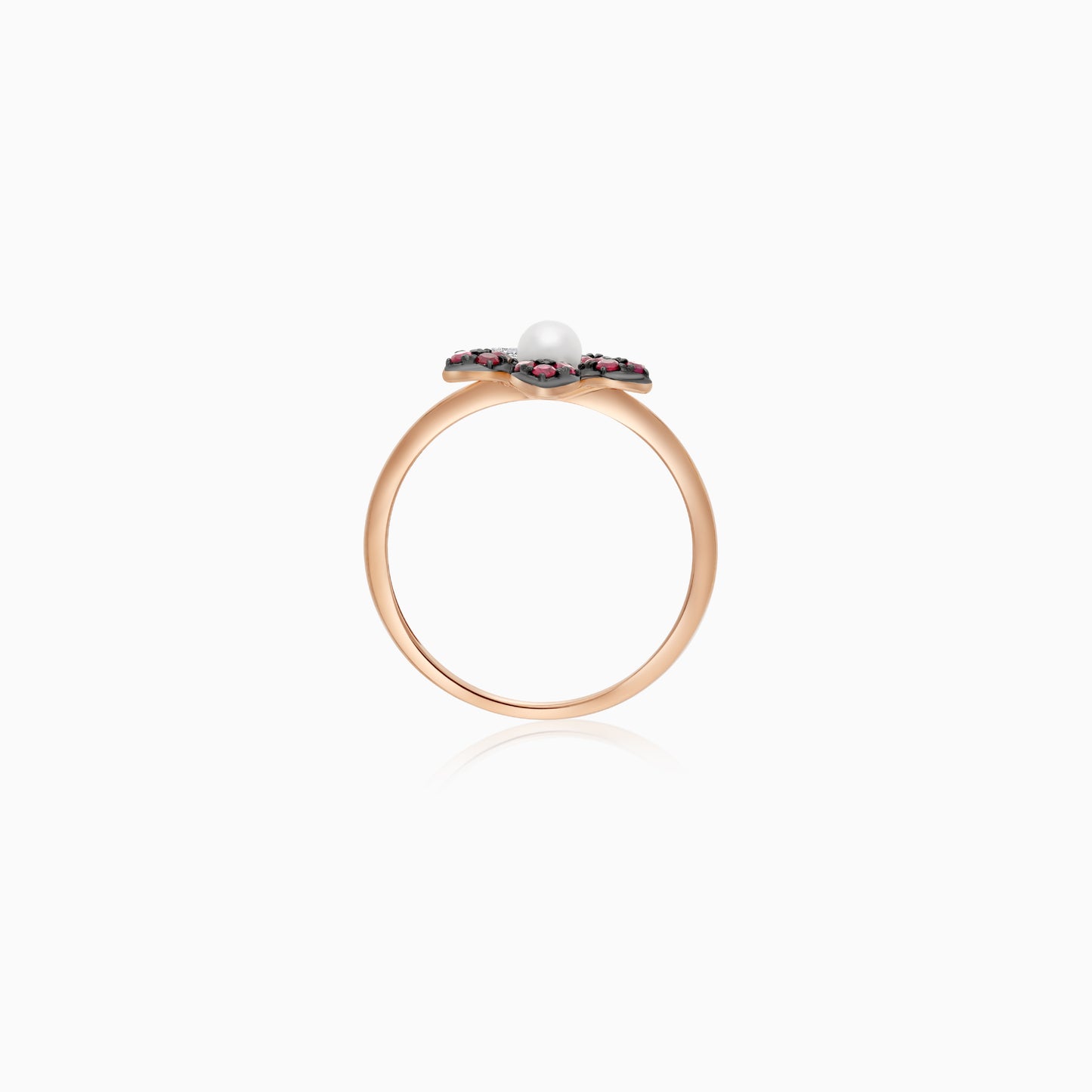 18k rose gold ring with a flower shape on the top decorated with natural diamonds, ruby stones and a single pearl in the center