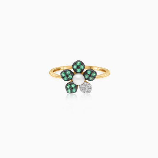 18k yellow gold ring with a flower shape on the top decorated with natural diamonds, emerald stones and a single pearl in the center