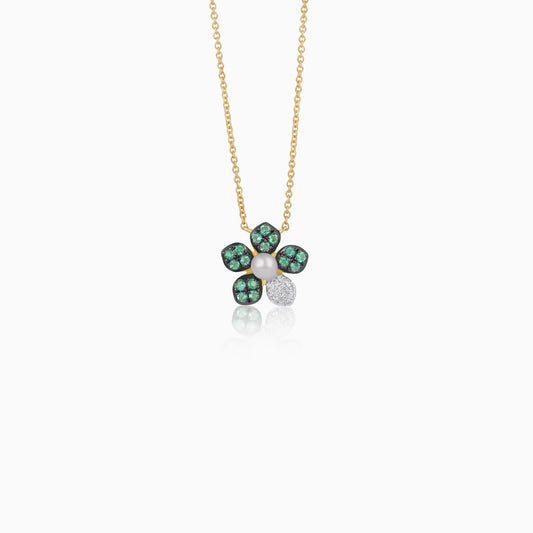 18k yellow gold chain with a flower shape pendant decorated with a single pearl in the center surrounded by natural diamond, emerald stones
