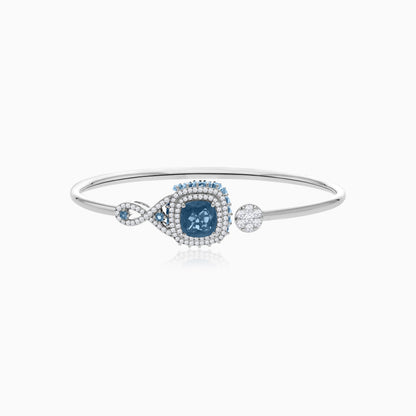 18K White Gold bangle featuring a stunning Natural Diamond and London blue Topaz stones