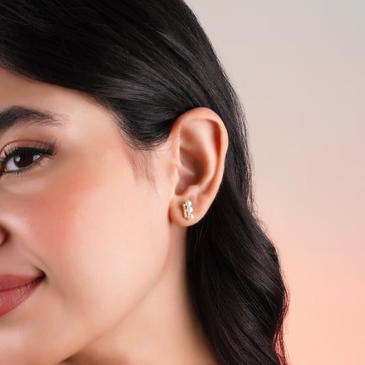 18k yellow gold earrings features 3 pearls aligning with zircon stones