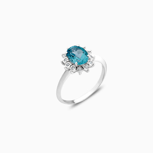 18K white gold ring decorated with natural Swiss blue Topaz stone surrounded by natural diamond stones