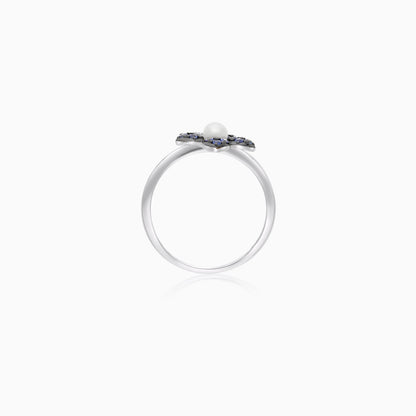 18k white gold ring with a flower shape on the top decorated with natural diamond, Sapphire stones and single pearl in the center