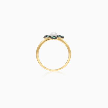 18k yellow gold ring with a flower shape on the top decorated with natural diamonds, emerald stones and a single pearl in the center