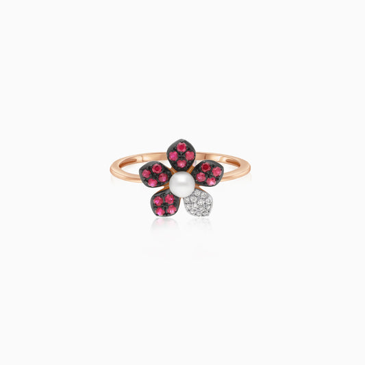 18k rose gold ring with a flower shape on the top decorated with natural diamonds, ruby stones and a single pearl in the center