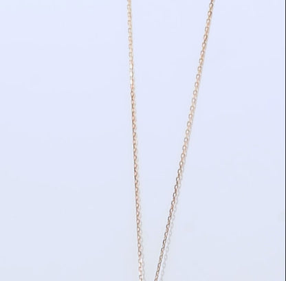 18k yellow gold necklace decorated by a single zircon stone in the centre surrounded by different sizes of pearls